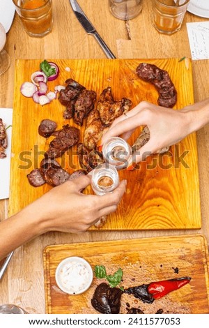 people drinking gin and Russian vodka at the table with shish kebab and a good appetizer, photo top view