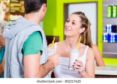 People Drinking Protein Shakes In Fitness Gym Bar