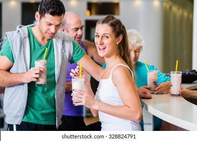 People Drinking Protein Shakes In Fitness Gym Bar