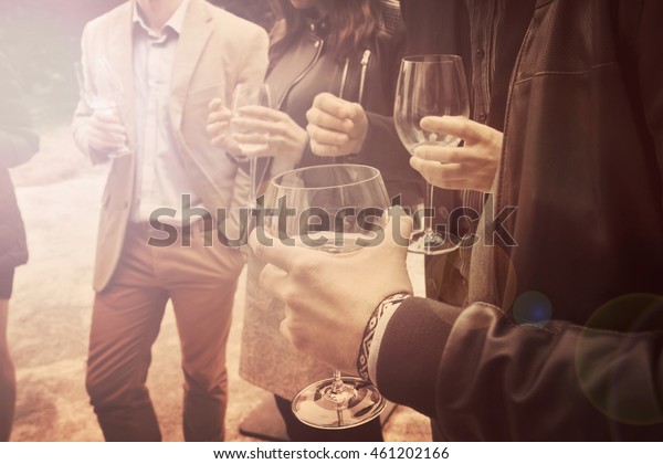 people drinking wine vintage effect, a group\
of friends is socializing and having a\
fun