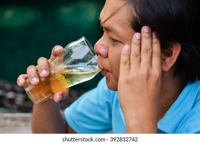 People, Drinks, Alcohol And Leisure Concept - Happy Young Man Drinking Beer 