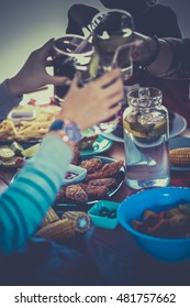 People with drinks while sitting at the dining table