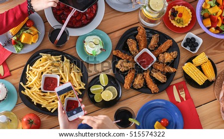 People with drinks while sitting at the dining table