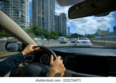 People driving car on city road - Shutterstock ID 2232756971