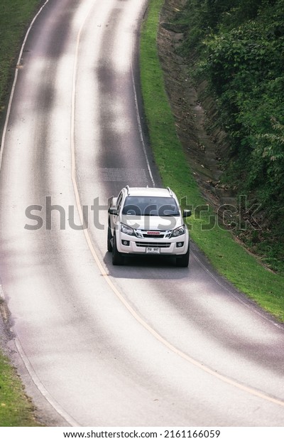 people driving on the road In the beautiful\
natural forest on both sides of the road\
On Khao Yai National Park\
in Thailand 16-05-2022