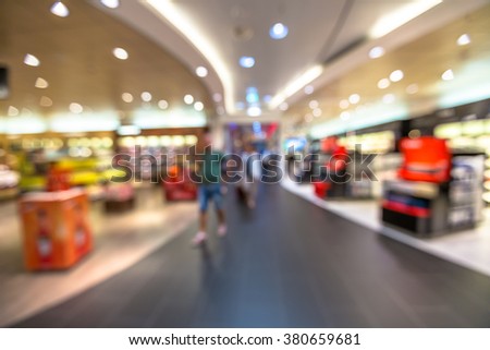People in the duty free shop at the airport. Blur effect.