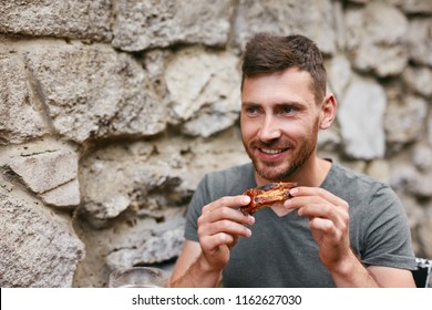 People Eat Food. Man Eating Barbecue Ribs In Grill Bar Closeup. Male Eating Spareribs In Steak House. High Resolution 