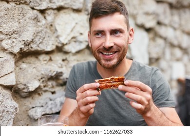 People Eat Food. Man Eating Barbecue Ribs In Grill Bar Closeup. Male Eating Spareribs In Steak House. High Resolution 