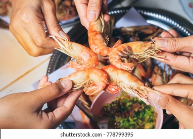 People Are  Eating  Grilled Shrimp With Fun And Happy In Holiday.