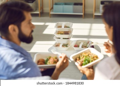 People Eating Healthy Food At Home Or In Office And Discussing Set Of Meals For The Whole Day. Stack Of Ordered And Delivered Takeaway Containers With Fresh Breakfast, Lunch And Dinner In Soft Focus