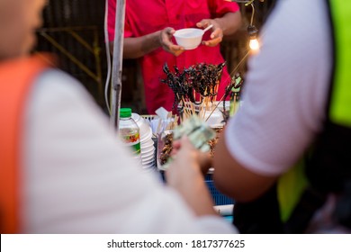 People Eating Scorpions In A Street 