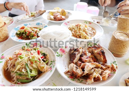 people eating Thai food together,place on the white table.
