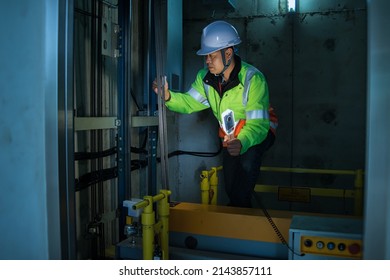 People in elevator shaft. service engineer checking inspector part of  elevator. worker check in lift shaft.