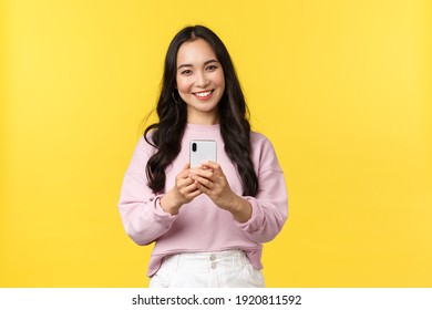 People Emotions, Lifestyle Leisure And Beauty Concept. Kawaii Smiling Asian Woman Taking Picture On Smartphone, Using Photo Filters To Edit Post In Application, Using Mobile Phone