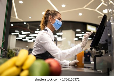 People endangered on their workplace because of corona virus. Cashier with protective hygienic mask and gloves working in supermarket and fighting against COVID-19 or corona virus pandemic.