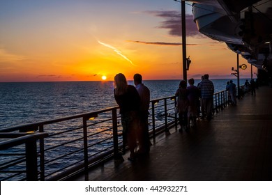 People Enjoy The Sunset Onboard A Cruise Ship In The North Atlantic.