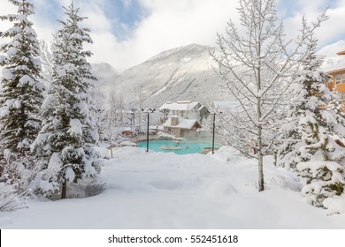 People Enjoying A Hot Tub In The Mountain Ski Resort.