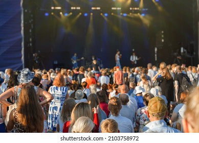 People Enjoying Musical Concert On Large Stage.