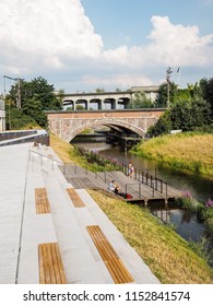 People Enjoying The Newly Opened Dyle River Bank At The Thomas More University Campus In Mechelen, Belgium