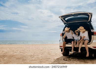 People enjoying road trip sitting down on back their car, Parents and children traveling in holiday at sea beach, family fun in summer vacation on beach blue sky, Happy Family and World Tourism Day - Powered by Shutterstock