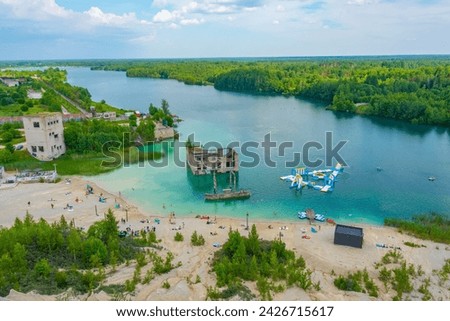People are enjoying a sunny day at a beach at Rummu quarry in Estonia.