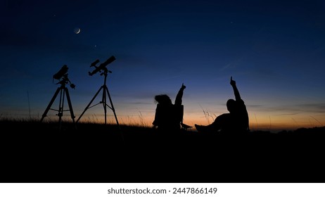 People enjoying watching and stargazing with astronomy telescopes outdoors in nature, observing planets, Moon and other celestial objects. - Powered by Shutterstock