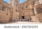 People enter to the Church of the Holy Sepulcher timelapse hyperlapse. Sacred place in the Christian Quarter of the Old City of Jerusalem where Jesus was crucified and buried.