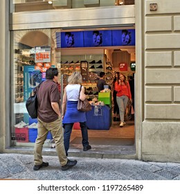 People Enter The Shoe Store. Shopping. Shop Windows. Urban Landscape. Italy, Florence - April 17, 2018   