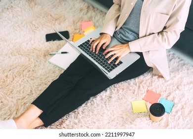 People Entrepreneur Freelance Business At Home Workplace Office Concept. No Face Woman Hand Typing Laptop Computer Keyboard Sitting On Carpet. Lifestyle With Internet Online Digital Tecnology.