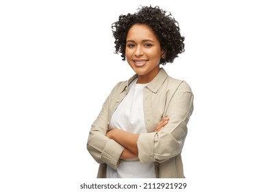 people, ethnicity and portrait concept - happy smiling woman in shirt with crossed arms over white background