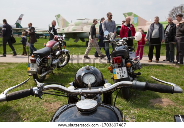 People\
examine old motorcycles during an exhibition of old vehicles in the\
aviation museum in Kyiv, Ukraine. April 25,\
2015.