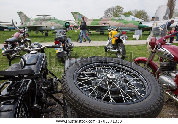 People\
examine old motorcycles during an exhibition of old vehicles in the\
aviation museum in Kyiv, Ukraine. April 25,\
2015.