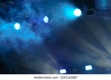 People are excited during street rock concert. They dance. Bright blue neon  lighting. Night life of the big city. Hands are raised up, the crowd is chanting. Back view - Shutterstock ID 2241163687