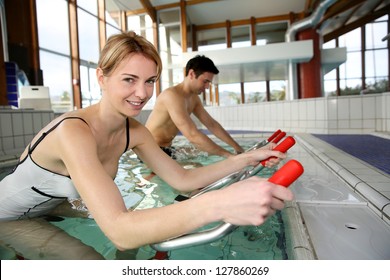 People Exercising With Aquatic Bikes In Spa Center