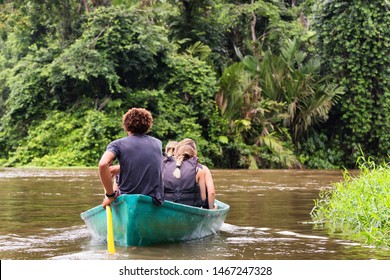 People Exploring A Wild Nature Area By Rowing Boat. Ecotourism Concept. Tortuguero National Park. Costa Rica.