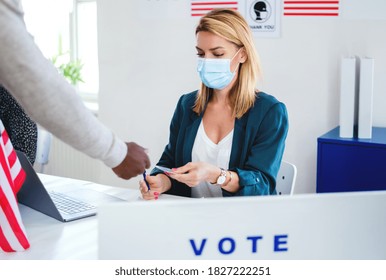 People With Face Mask Voting In Polling Place, Usa Elections And Coronavirus.