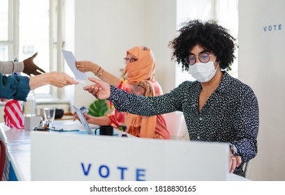 People With Face Masks Voting In Polling Place, Usa Elections And Coronavirus.