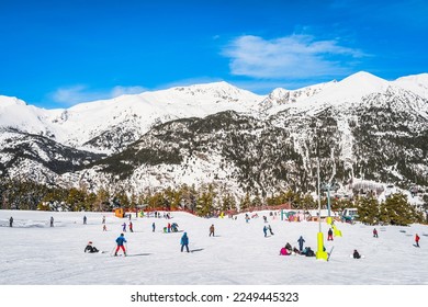 People, families and kids having fun and learning how to ski and snowboard on El Tarter green slops. Winter ski holidays in Andorra Pyrenees Mountains - Shutterstock ID 2249445323