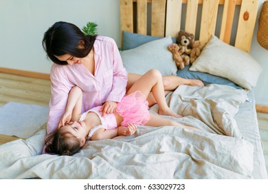 People, Family And Concept In The Morning - Happy Daughter With Mom Waking Up In Bed At Home