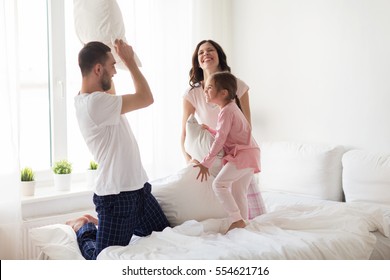 People, Family And Morning Concept - Happy Child With Parents Waking Up In Bed At Home