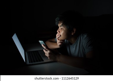 People Feel Something On His Phone In The Dark Room. Asia.