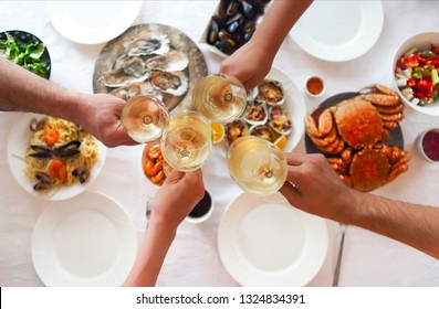 People Fine Dining Seafood And White Wine On The Table. Top View