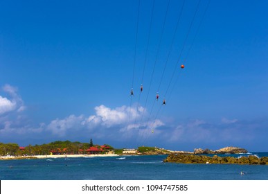 People Flying At High Zipline On Caribbean At Labadee Island At Haiti