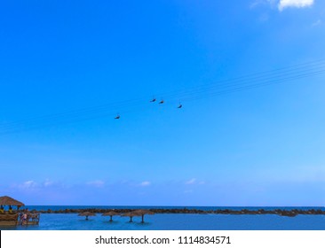 People Flying At High Zipline On Caribbean At Labadee Island At Haiti