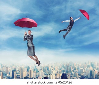 People Flying In The Sky With Umbrellas