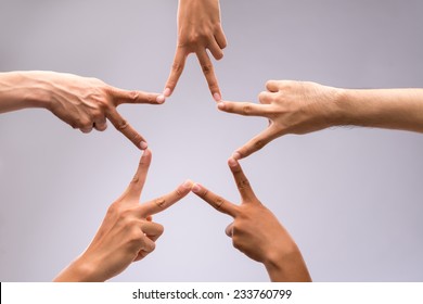 People Forming Star Shape With Their Fingers