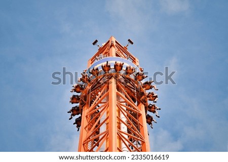 People free falling from tower ride at amusement park. Free Fall Tower in the amusement park.