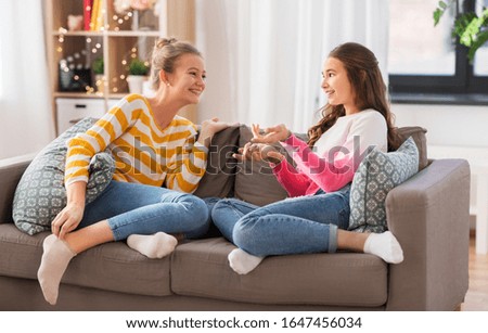 Similar – Sisters, teenage girl and her younger sister pushing hay bale playing together outdoors in the countryside