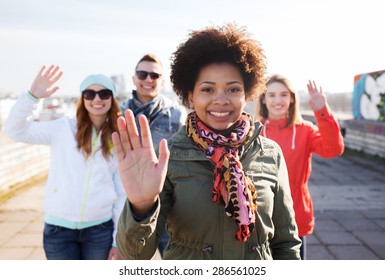 People, Friendship And International Concept - Happy African American Young Woman Or Teenage Girl In Front Of Her Friends Waving Hands On City Street