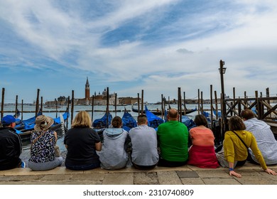 People in front of the sea - Shutterstock ID 2310740809